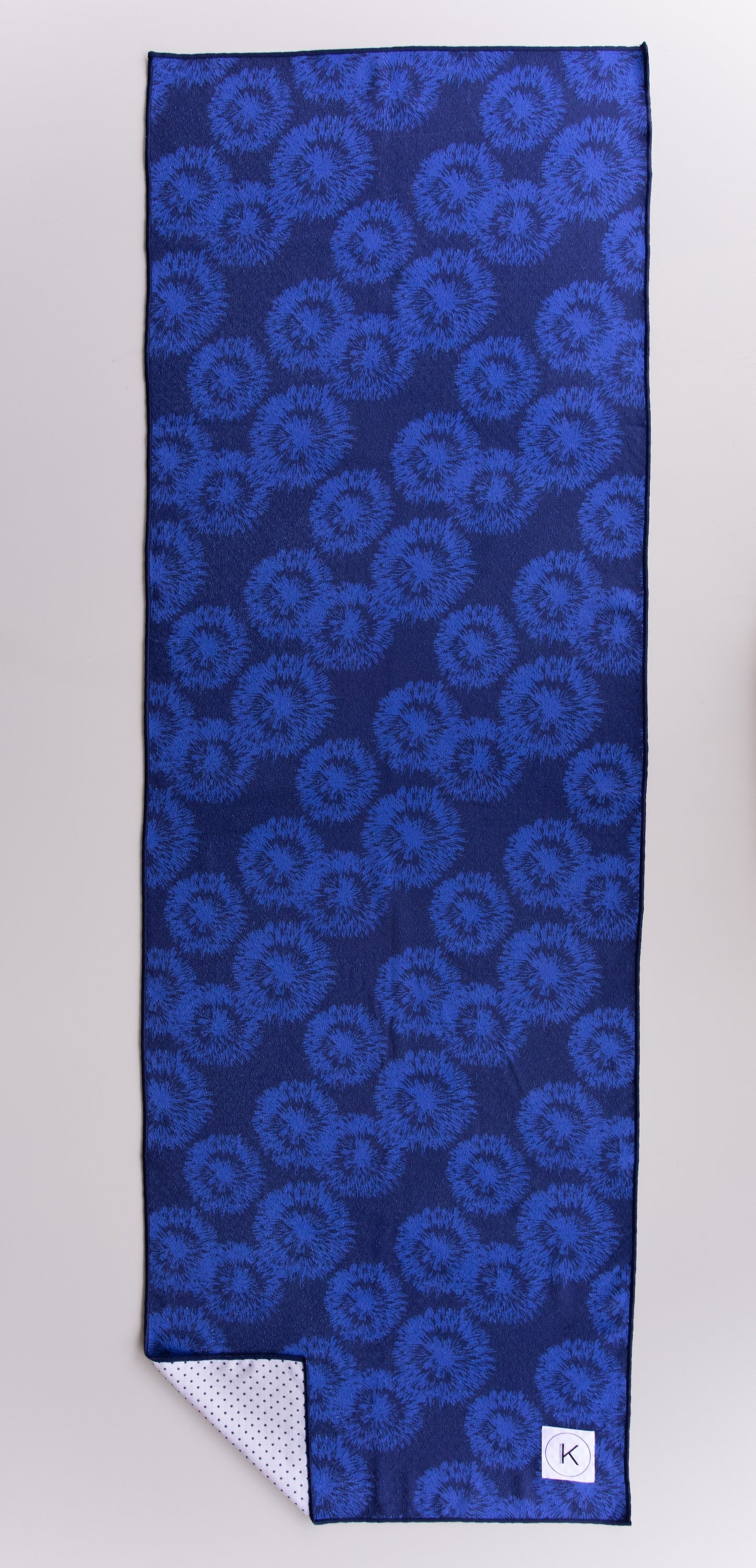 Eco-friendly kaleidoscope yoga towels with bold prints for men and women practicing hot yoga.