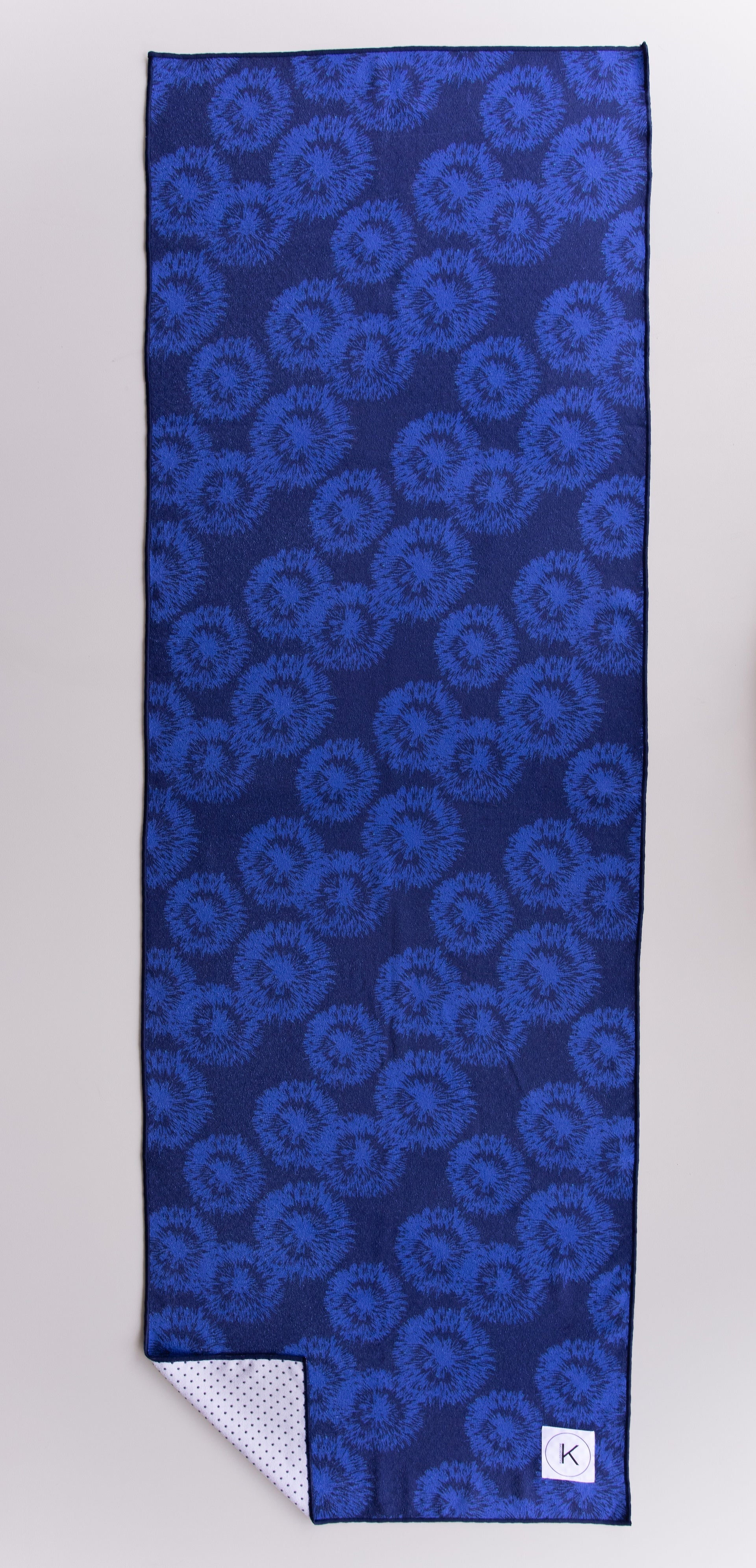 Eco-friendly kaleidoscope yoga towels with bold prints for men and women practicing hot yoga.