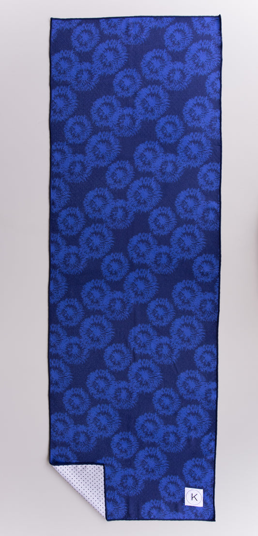Eco-friendly kaleidoscope yoga towels with bold prints for men and women practicing hot yoga.
